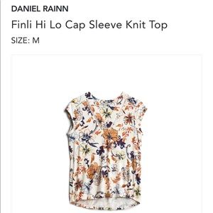 Floral top with decorative neck and shoulder line.